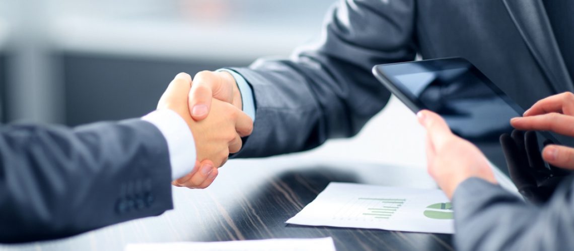 Business people shaking hands in office